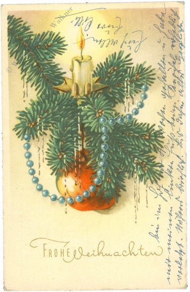 weihnachten: geschmückter christbaumzweig mit kerze