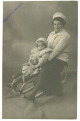 Mutter mit Kind auf Schlitten