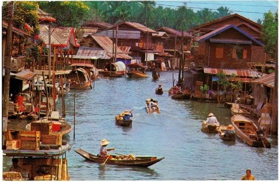 A view of a group of Villagers Houses near a Canal (or Khlong) in Thailand